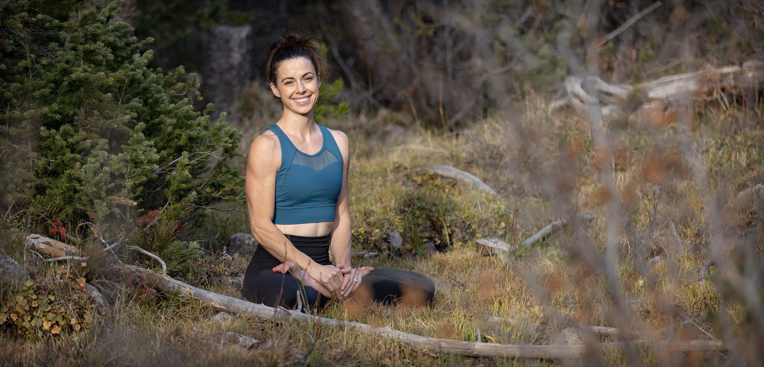 Holly Semanoff seated outdoors among trees